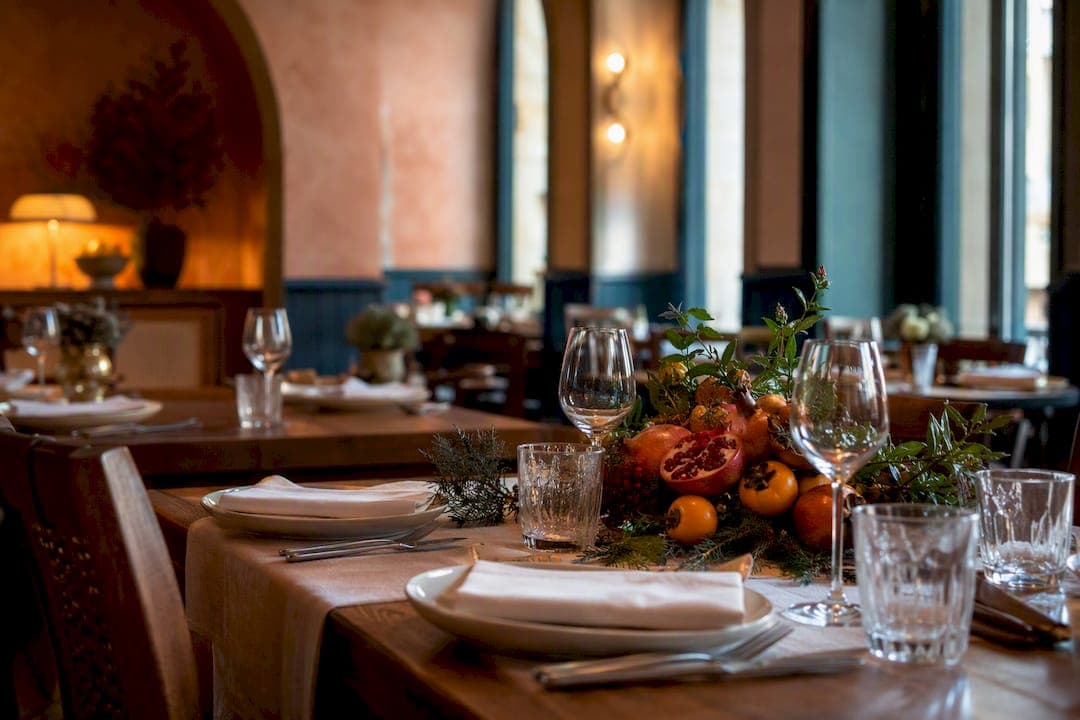 Warm restaurant table setting with seasonal decor