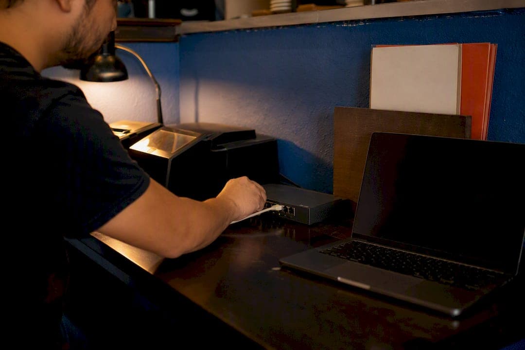 Hand plugging network cable in restaurant office