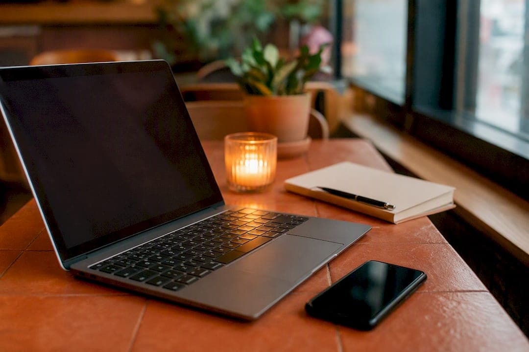 Smartphone and laptop on restaurant table