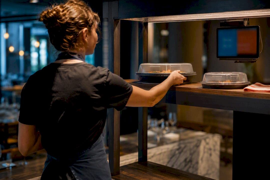 Server collecting a ready restaurant order